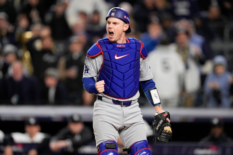 Los Angeles Dodgers catcher Will Smith celebrates after tagging New York Yankees' out at home during the fourth inning in Game 3 of the baseball World Series, Monday, Oct. 28, 2024, in New York. (AP Photo/Ashley Landis)