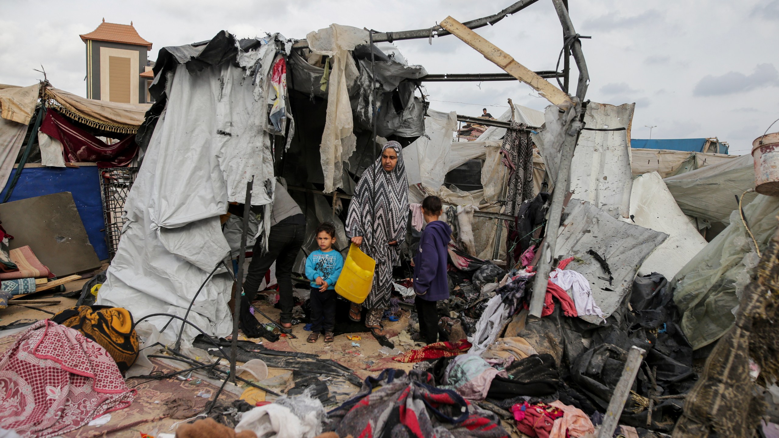 FILE - Displaced Palestinians inspect their tents destroyed by Israel's bombardment, adjunct to an UNRWA facility west of Rafah city, Gaza Strip, Tuesday, May 28, 2024. (AP Photo/Jehad Alshrafi, File)