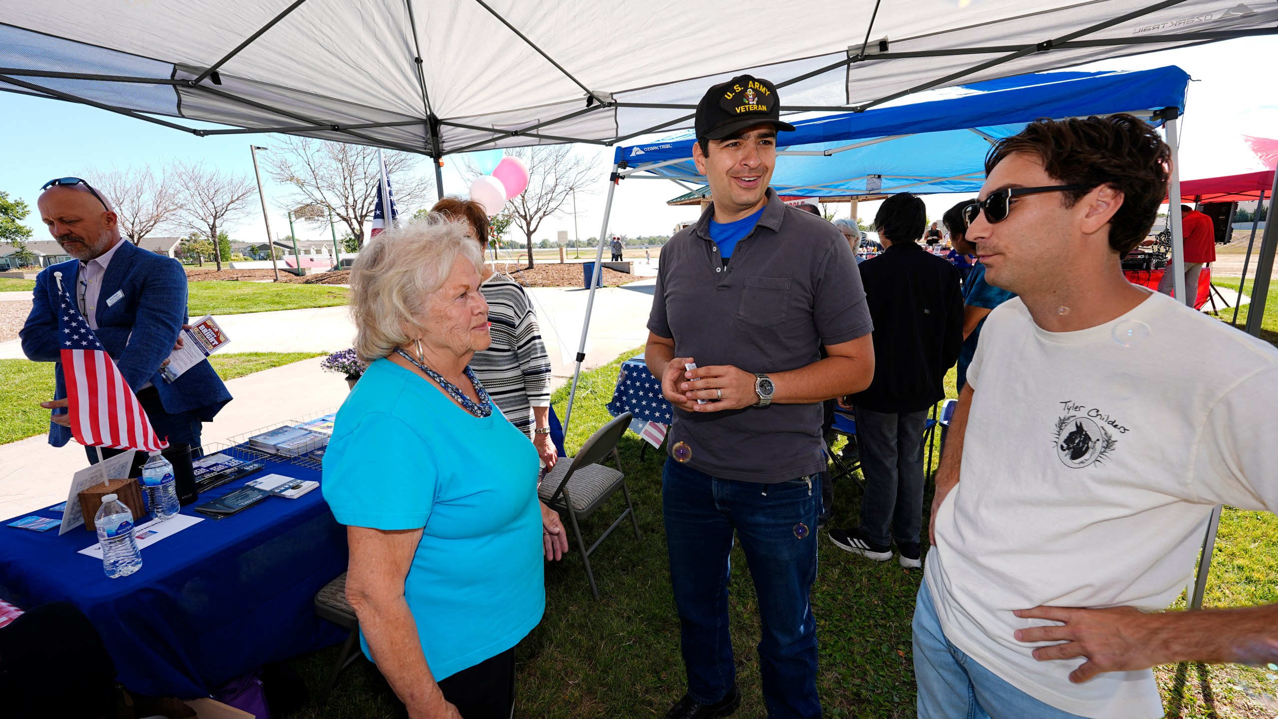 Gabe Evans, Republican candidate for the U.S. House District 8 in Colorado, talks to Annette Hayes during a campaign stop Saturday, Sept. 28, 2024, in Evans, Colo. (AP Photo/David Zalubowski)