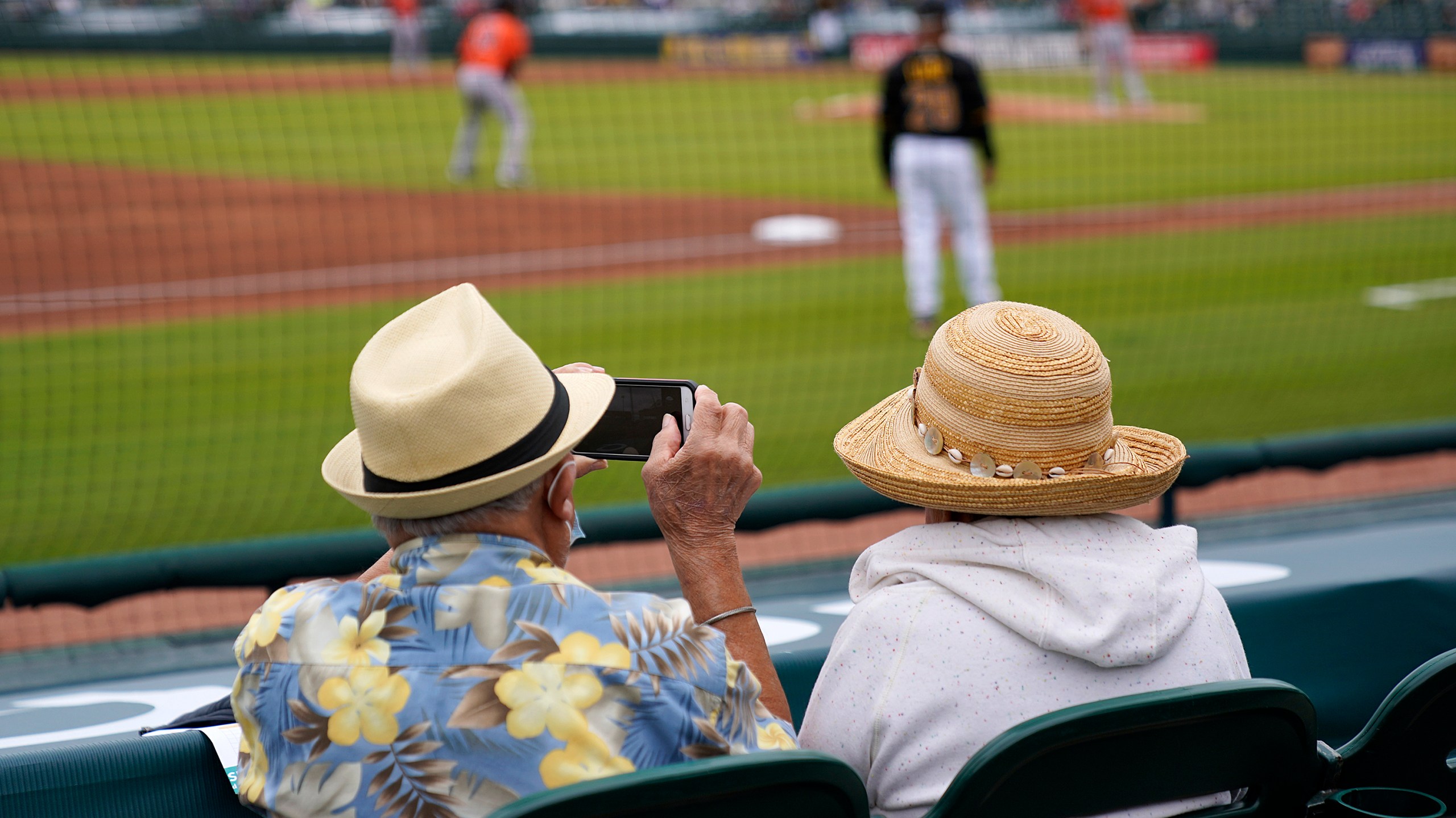 FILE - Baseball fans watch a spring training exhibition baseball game between the Pittsburgh Pirates and the Baltimore Orioles in Bradenton, Fla., March 22, 2021. (AP Photo/Gene J. Puskar, File)