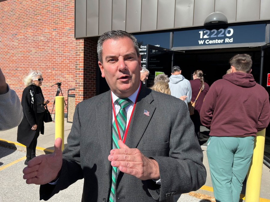 Douglas County Election Commissioner Brian Kruse stands outside the county's main election office as people line up to vote and register to vote in Omaha, Neb. on Wednesday, Oct. 16, 2024 . (AP Photo/Margery A. Beck)