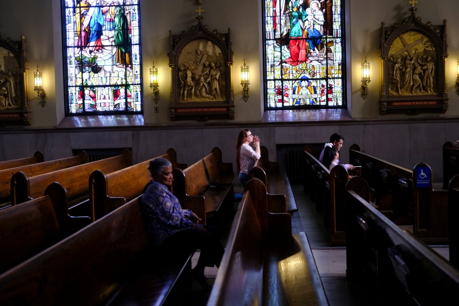 FILE - A parishioner prays at St. Peter the Apostle Catholic Church in Reading, Pa., on June 16, 2024. (AP Photo/Luis Andres Henao)