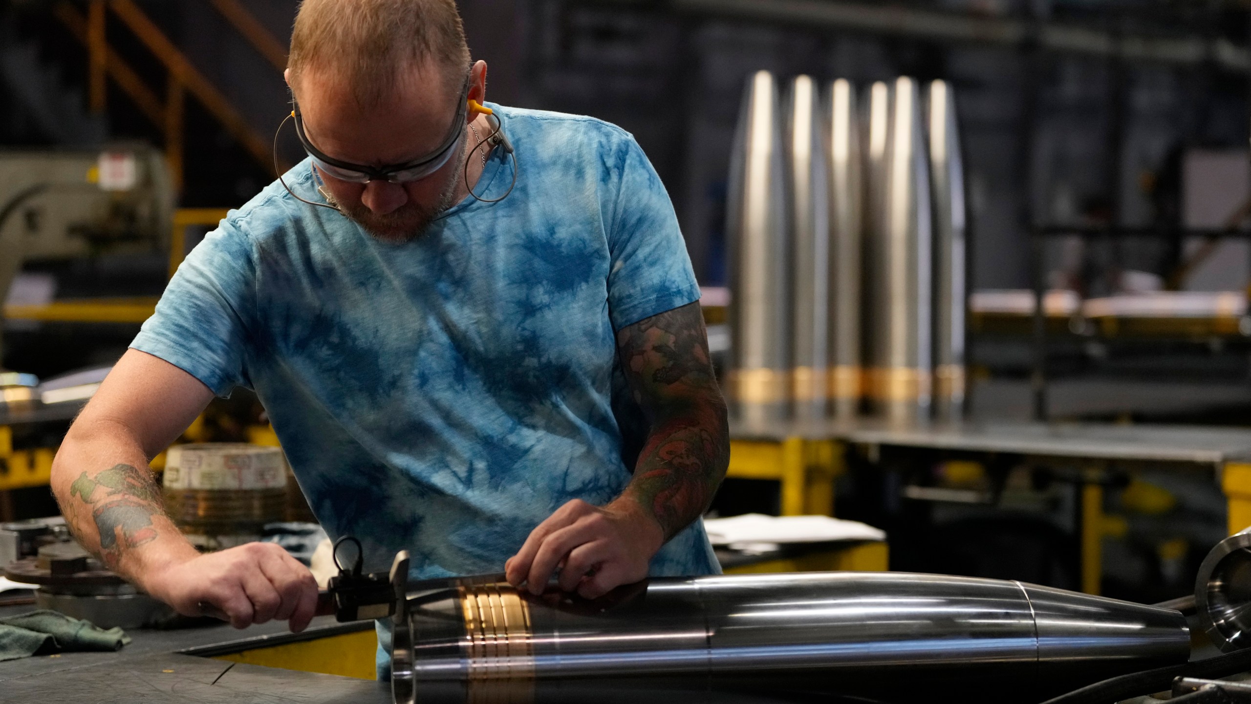 FILE - A steel worker inspects a 155 mm M795 artillery projectile at the Scranton Army Ammunition Plant, Aug. 27, 2024, in Scranton, Pa. (AP Photo/Matt Slocum, File)