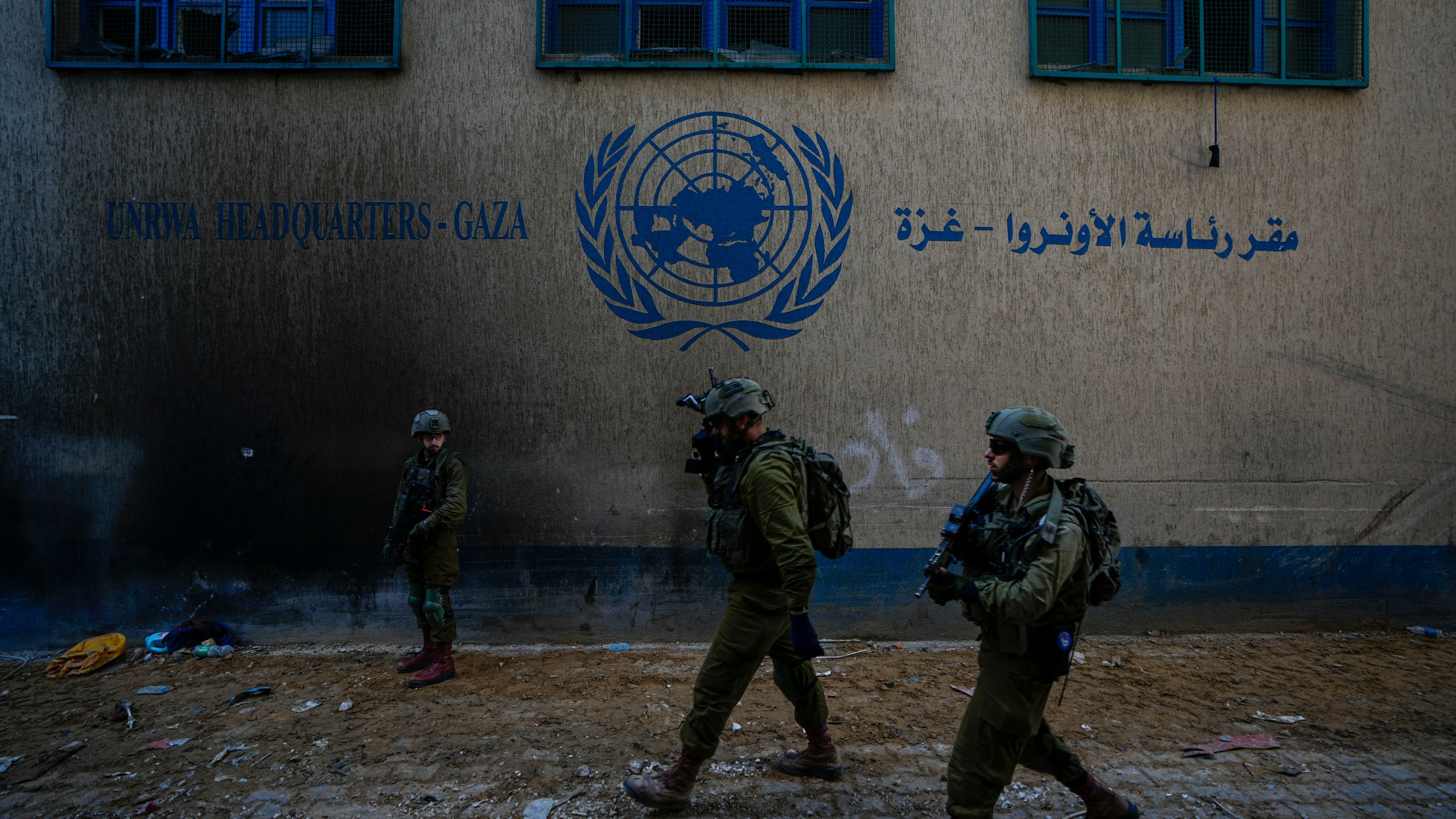 FILE - Israeli soldiers take position as they enter the UNRWA headquarter where the military discovered tunnels underneath of the U.N. agency that the military says Hamas militants used to attack its forces during a ground operation in Gaza, Thursday, Feb. 8, 2024. (AP Photo/Ariel Schalit, File)