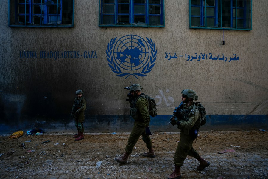 FILE - Israeli soldiers take position as they enter the UNRWA headquarter where the military discovered tunnels underneath of the U.N. agency that the military says Hamas militants used to attack its forces during a ground operation in Gaza, Thursday, Feb. 8, 2024. (AP Photo/Ariel Schalit, File)