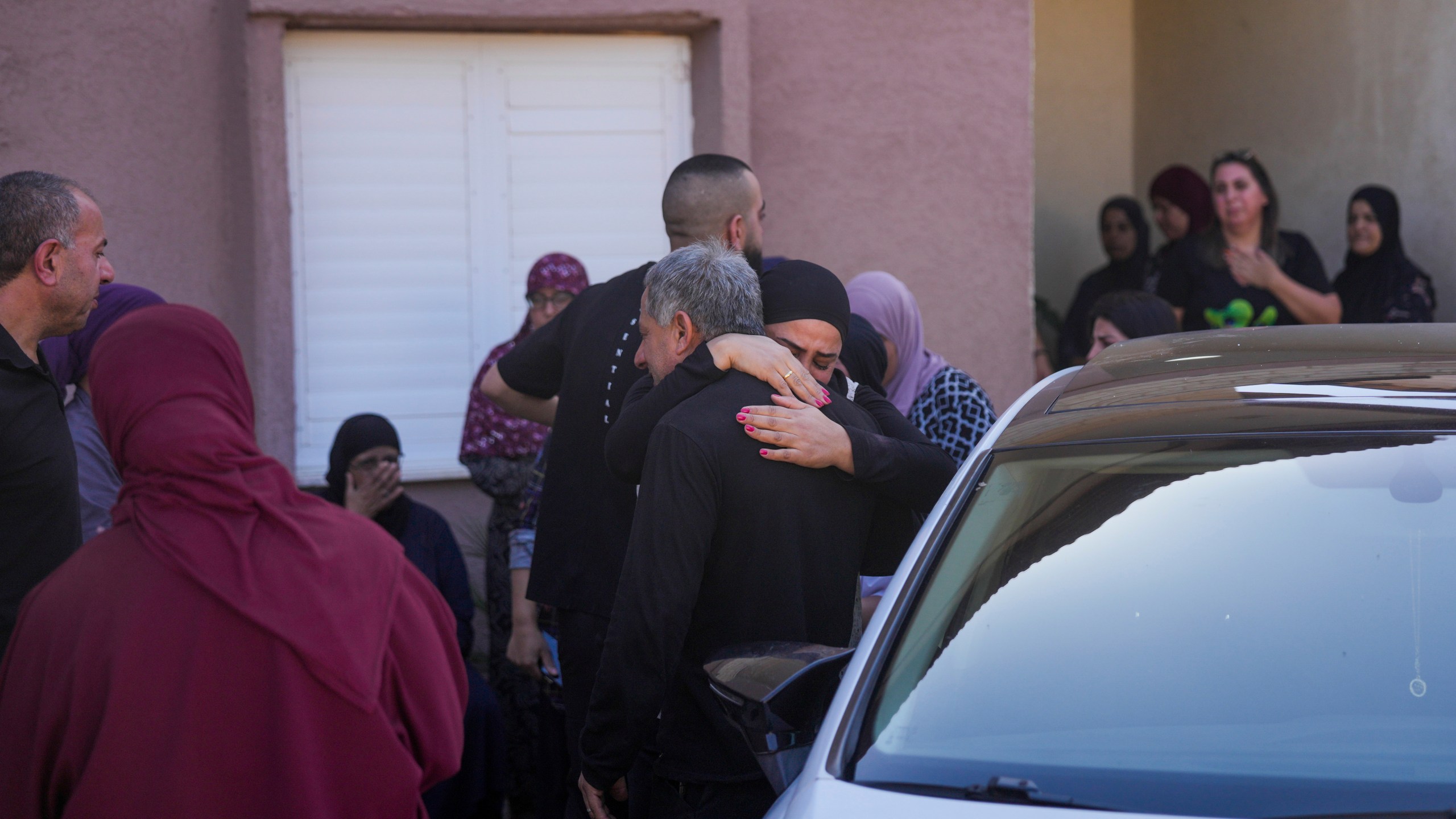 People react at the site where one person was killed after a projectile launched from Lebanon slammed into Maalot-Tarshiha, northern Israel, Tuesday, Oct. 29, 2024. (AP Photo/Ohad Zwigenberg)