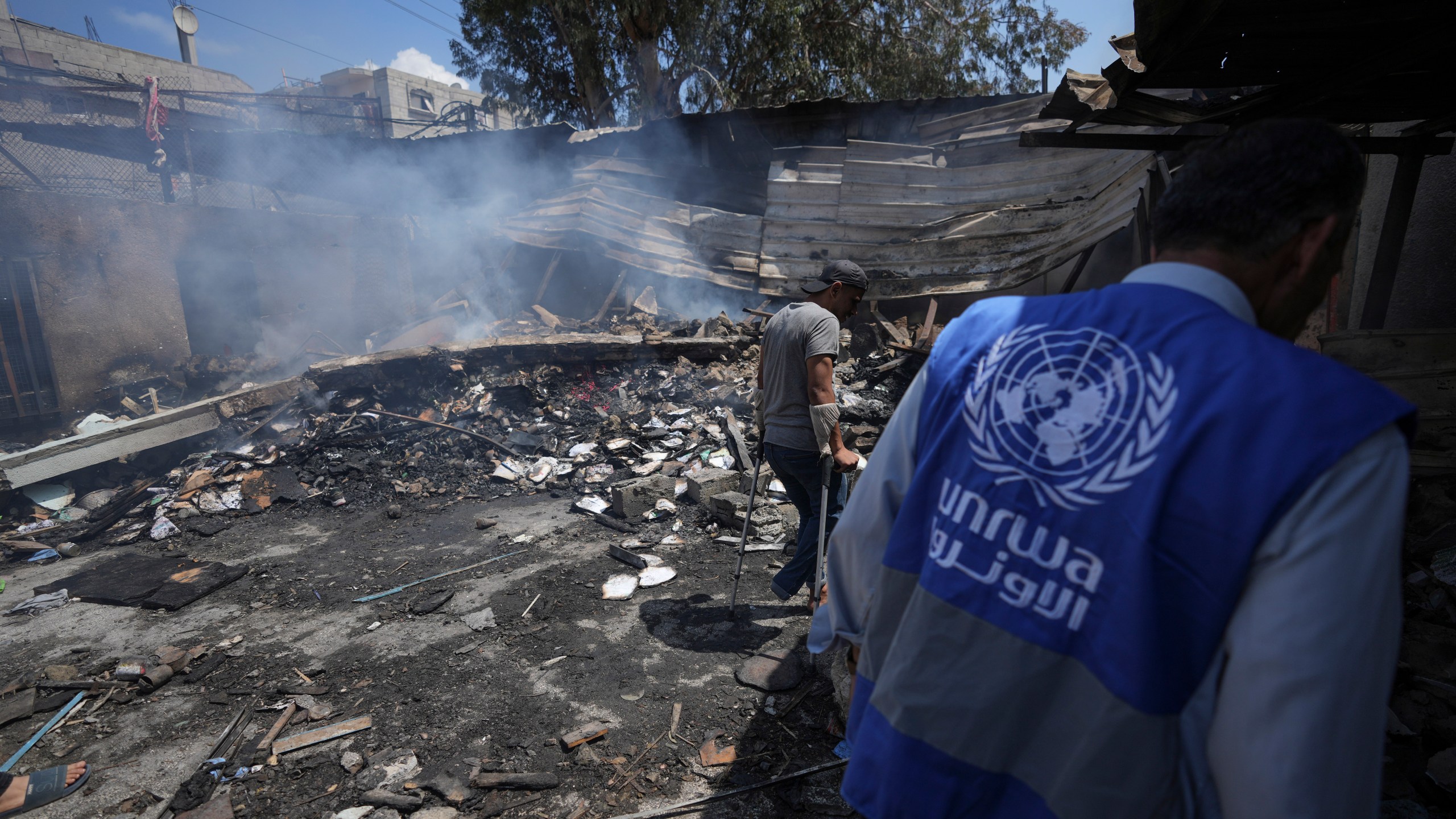 FILE - Palestinians look at the destruction after an Israeli strike on a school run by UNRWA, the U.N. agency helping Palestinian refugees, in Nuseirat, Gaza Strip, May 14, 2024. (AP Photo/Abdel Kareem Hana, File)