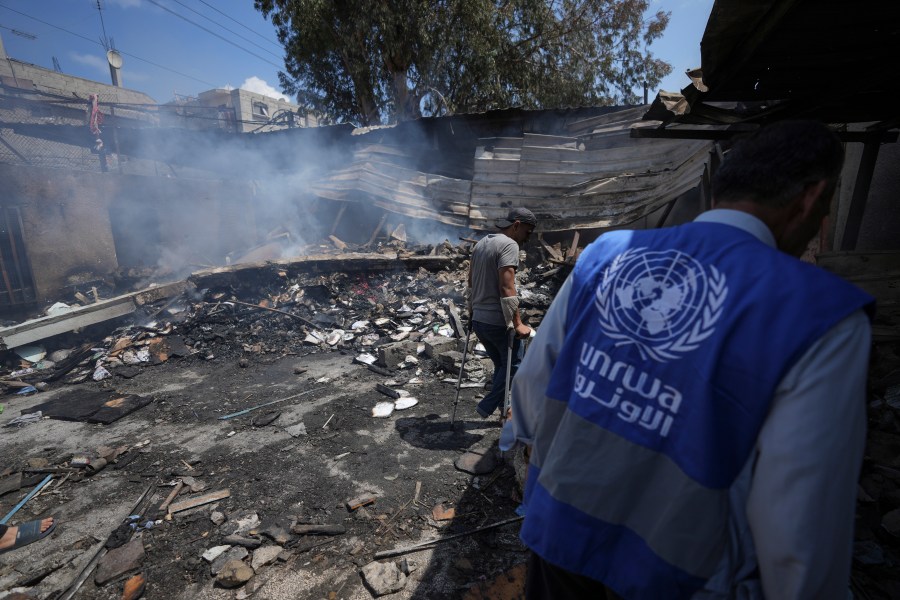 FILE - Palestinians look at the destruction after an Israeli strike on a school run by UNRWA, the U.N. agency helping Palestinian refugees, in Nuseirat, Gaza Strip, May 14, 2024. (AP Photo/Abdel Kareem Hana, File)