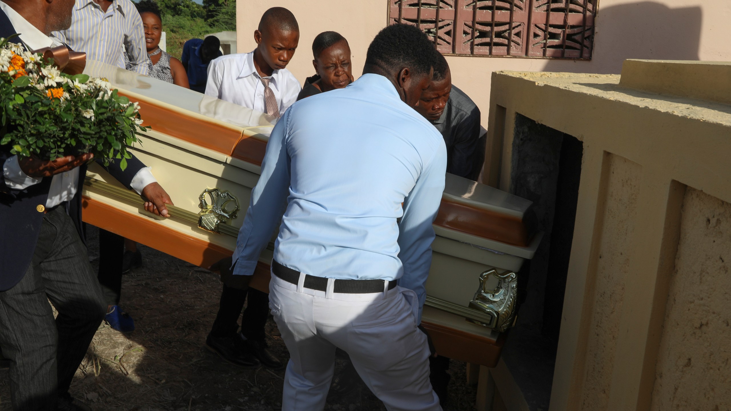 Relatives carry the coffin of Jean Louis Jeune Gracien, who was killed during an attack by armed gangs, at his funeral in Pont-Sonde, Haiti, Tuesday, Oct. 8, 2024. (AP Photo/Odelyn Joseph)