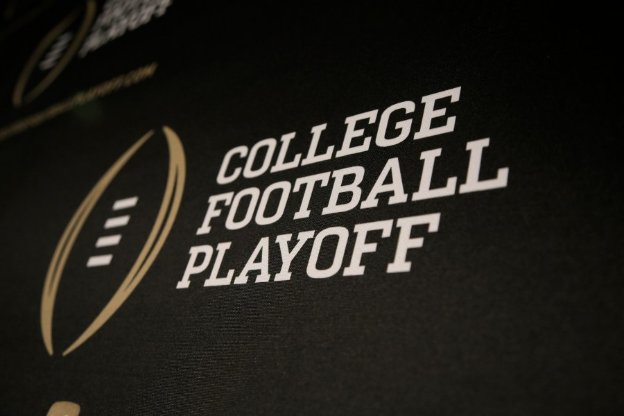 FILE - The College Football Playoff logo is printed across a backdrop during a news conference where the 13 members of the committee were announced, Oct. 16, 2013, in Irving, Texas. (AP Photo/Tony Gutierrez, File)