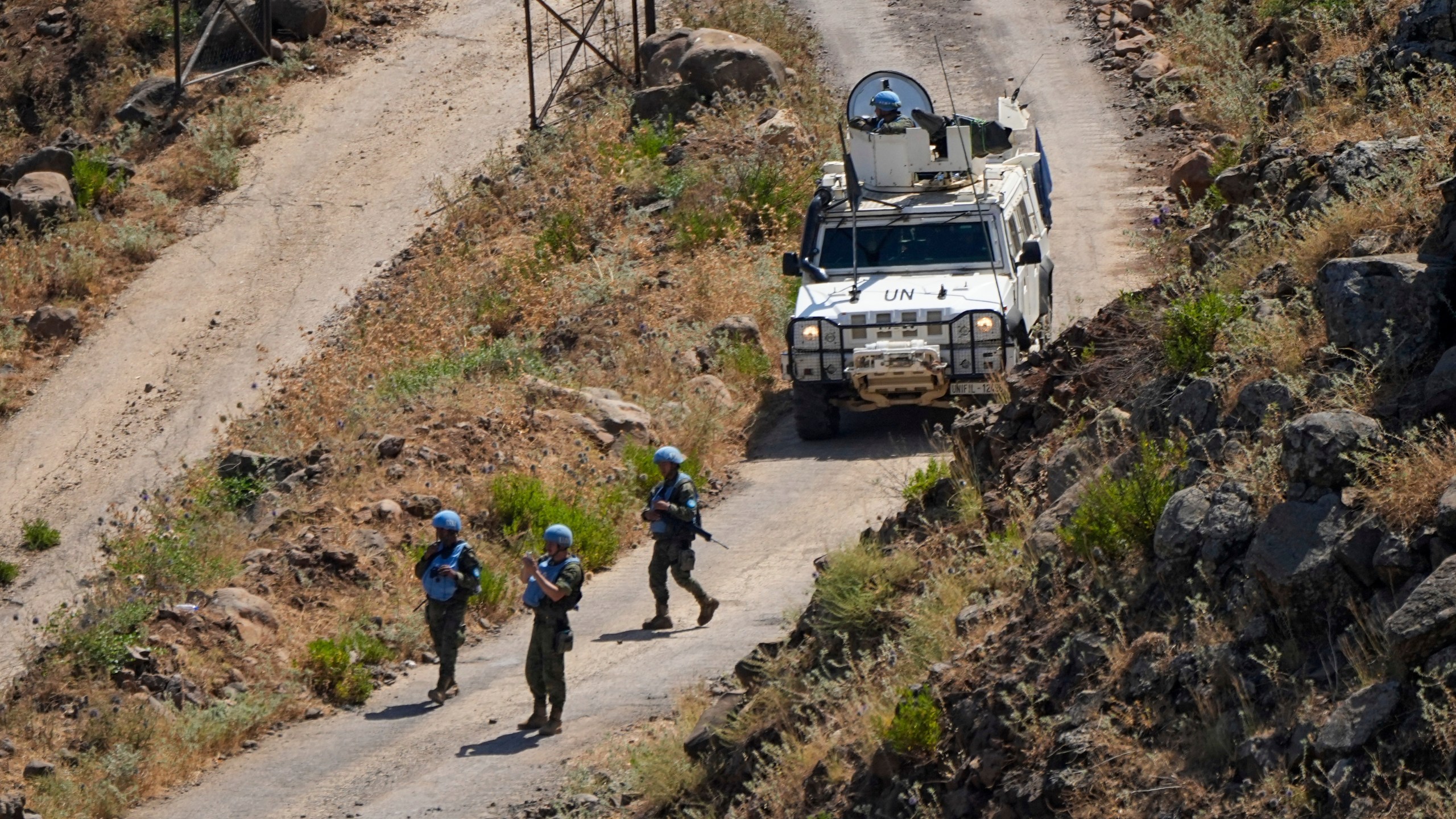 FILE -UN peacekeepers (UNIFIL) patrol along the Lebanese side of the border with Israel, seen from Israel, Thursday, July 6, 2023. (AP Photo/Ariel Schalit, File)