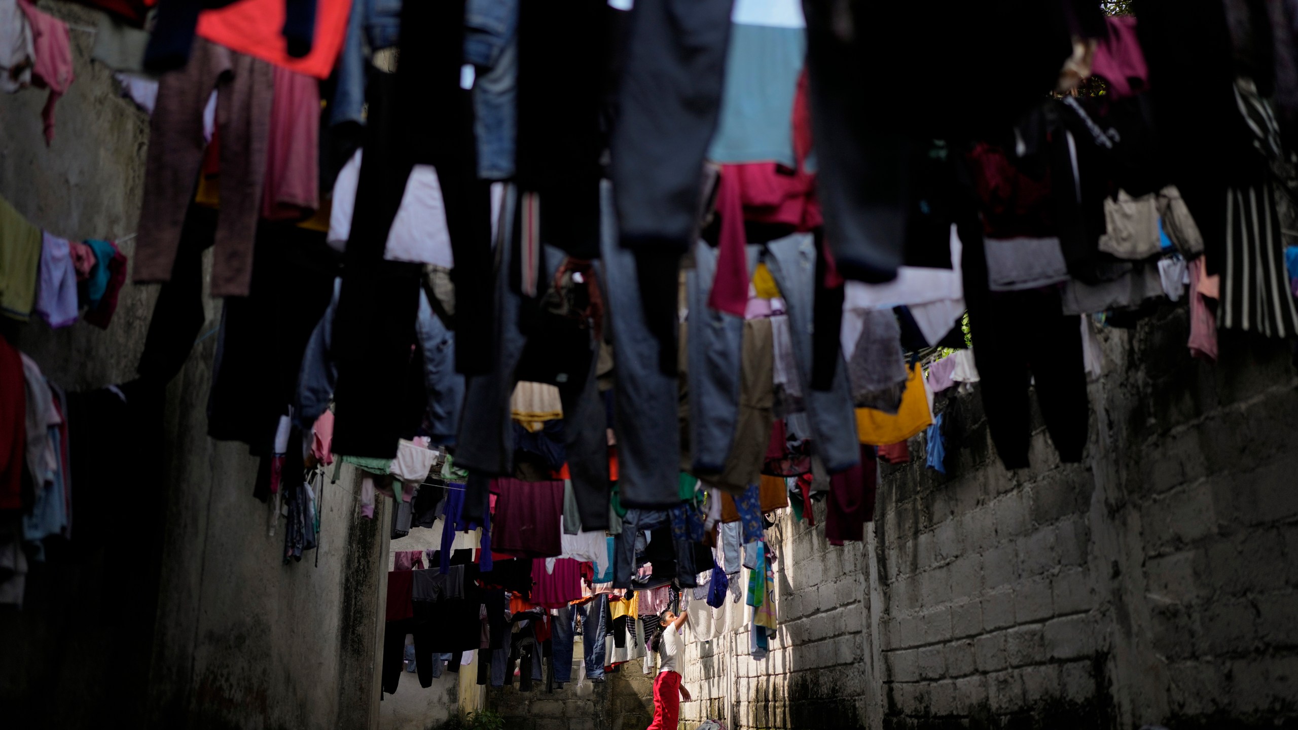 Honduran migrant Anyi Espinal dries her clothes in a shelter in Tapachula, Mexico, Monday, Oct. 28, 2024. (AP Photo/Matias Delacroix)