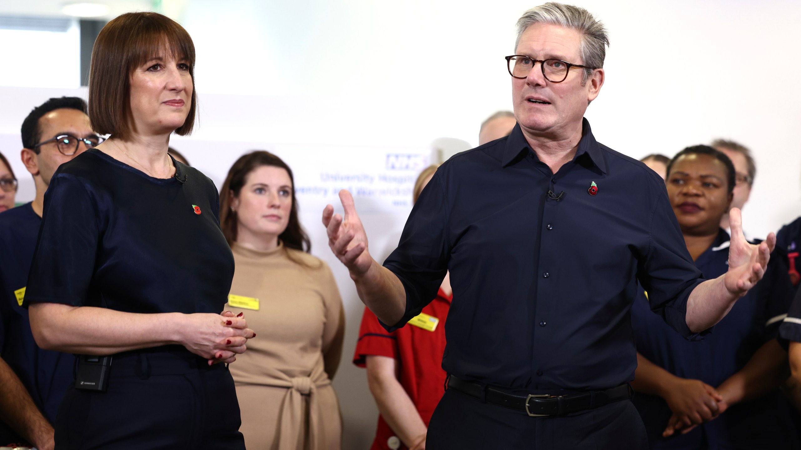 Britain's Prime Minister Keir Starmer and Chancellor Rachel Reeves speak with members of staff, during a visit to University Hospital Coventry and Warwickshire, in Coventry, England, Thursday, Oct. 31, 2024. (AP Photo/Darren Staples, pool)