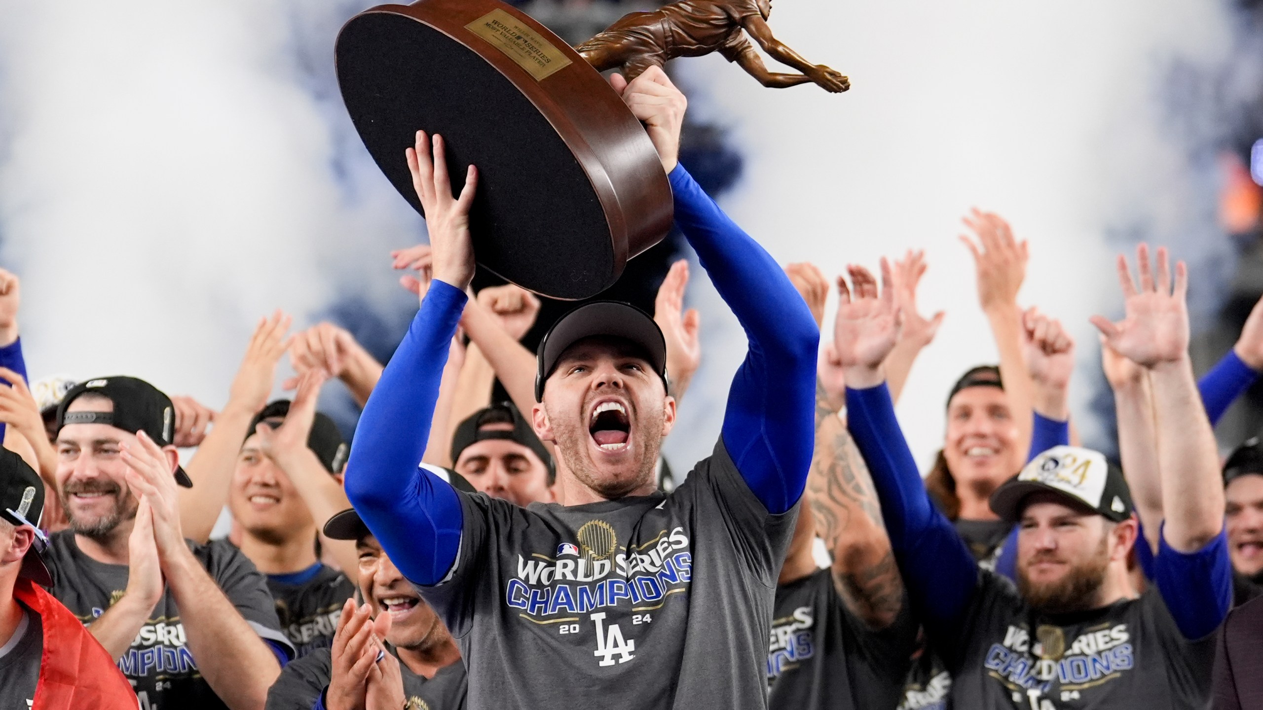 Los Angeles Dodgers' Freddie Freeman celebrates with the MVP trophy after their win against the New York Yankees in Game 5 to win the baseball World Series, Thursday, Oct. 31, 2024, in New York. (AP Photo/Ashley Landis)