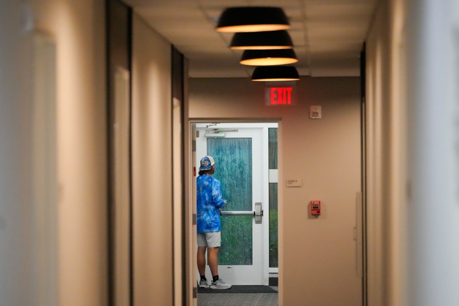 Davis Jones, an insurance adjuster from Biloxi, Miss., looks out the door of the hotel where he is riding out Hurricane Milton, Wednesday, Oct. 9, 2024, in Tampa, Fla.