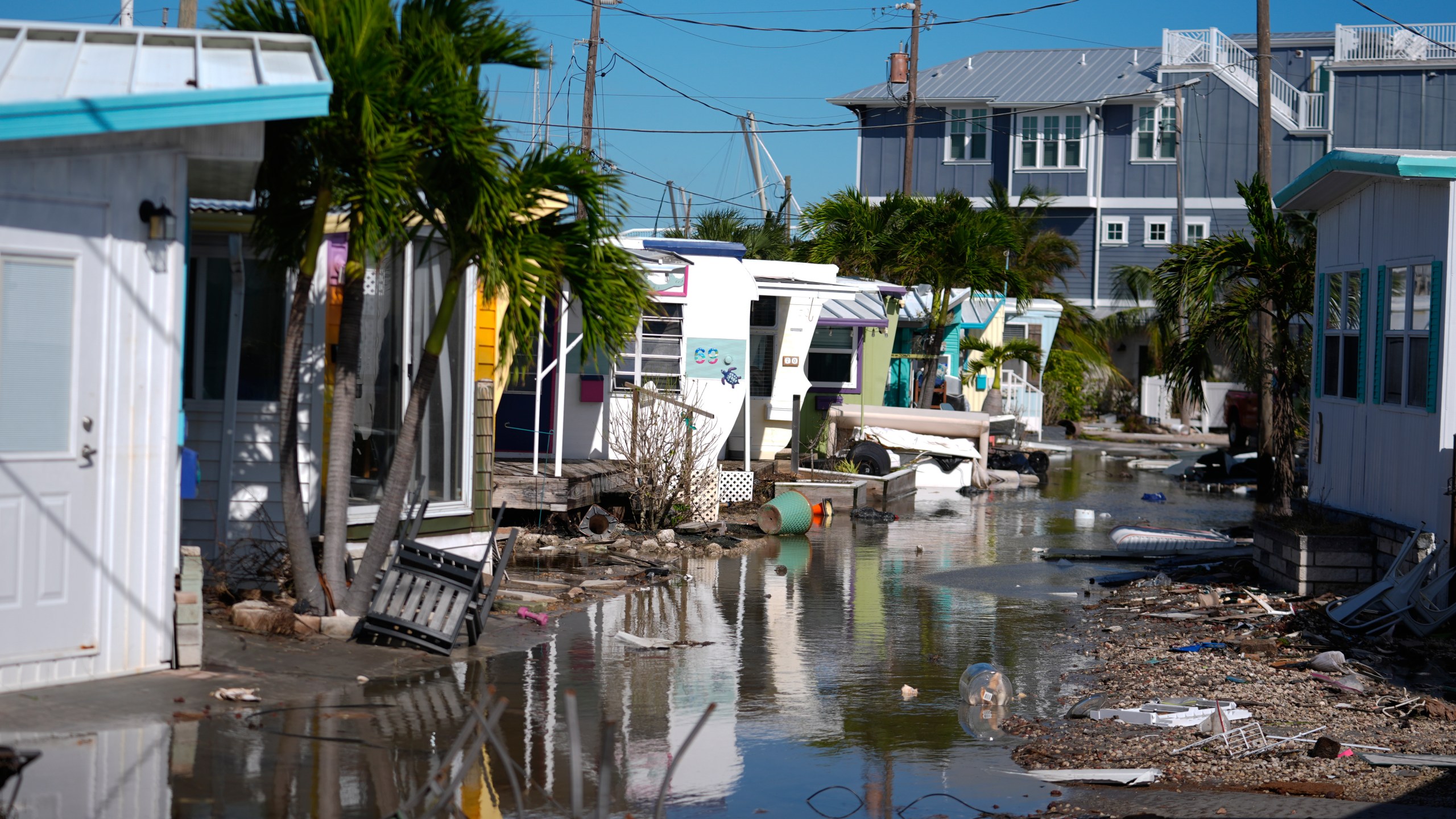 Water left by Hurricane Milton floods a road inside Pines Trailer Park in Bradenton Beach on Anna Maria Island, Florida.