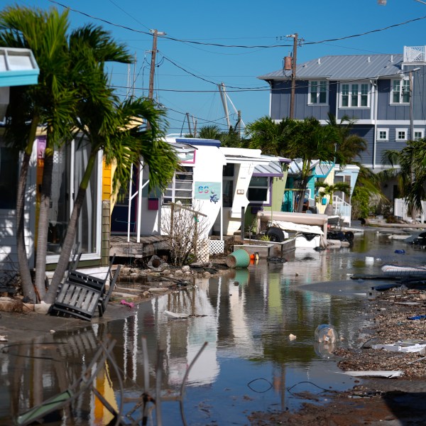 Water left by Hurricane Milton floods a road inside Pines Trailer Park in Bradenton Beach on Anna Maria Island, Florida.