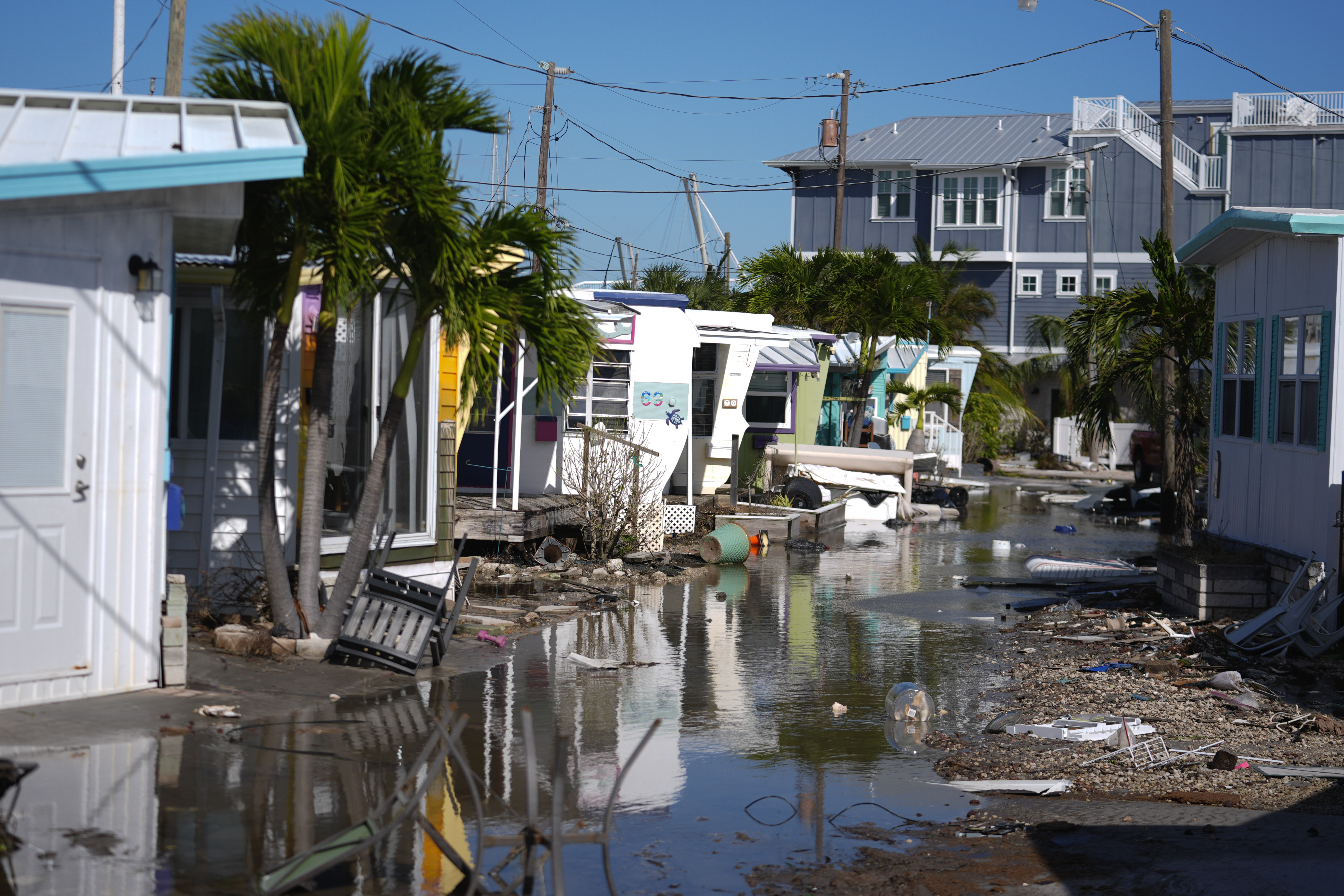 Water left by Hurricane Milton floods a road inside Pines Trailer Park in Bradenton Beach on Anna Maria Island, Florida.