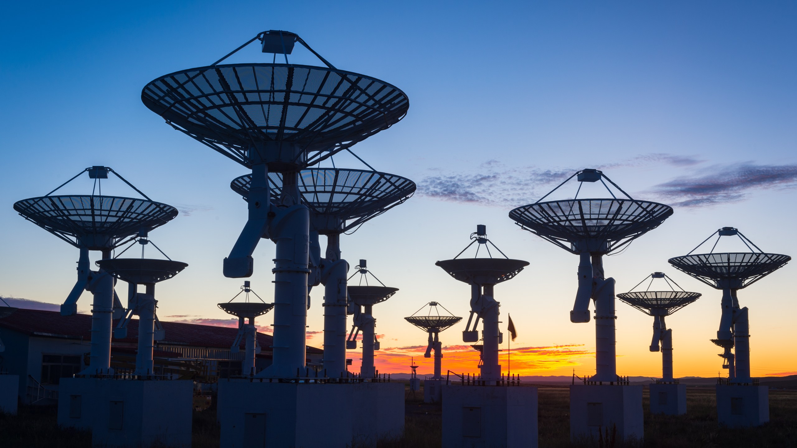 An observatory antenna in the sunset.