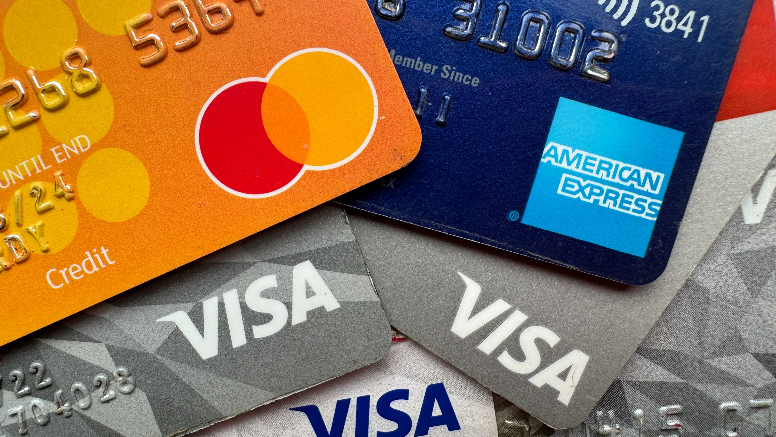 Visa, Mastercard and American Express logos are seen on credit and debit cards.