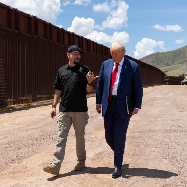 National Border Patrol Council board member Art Del Cueto walks with former President Donald Trump along the U.S.-Mexico border on August 22, 2024.