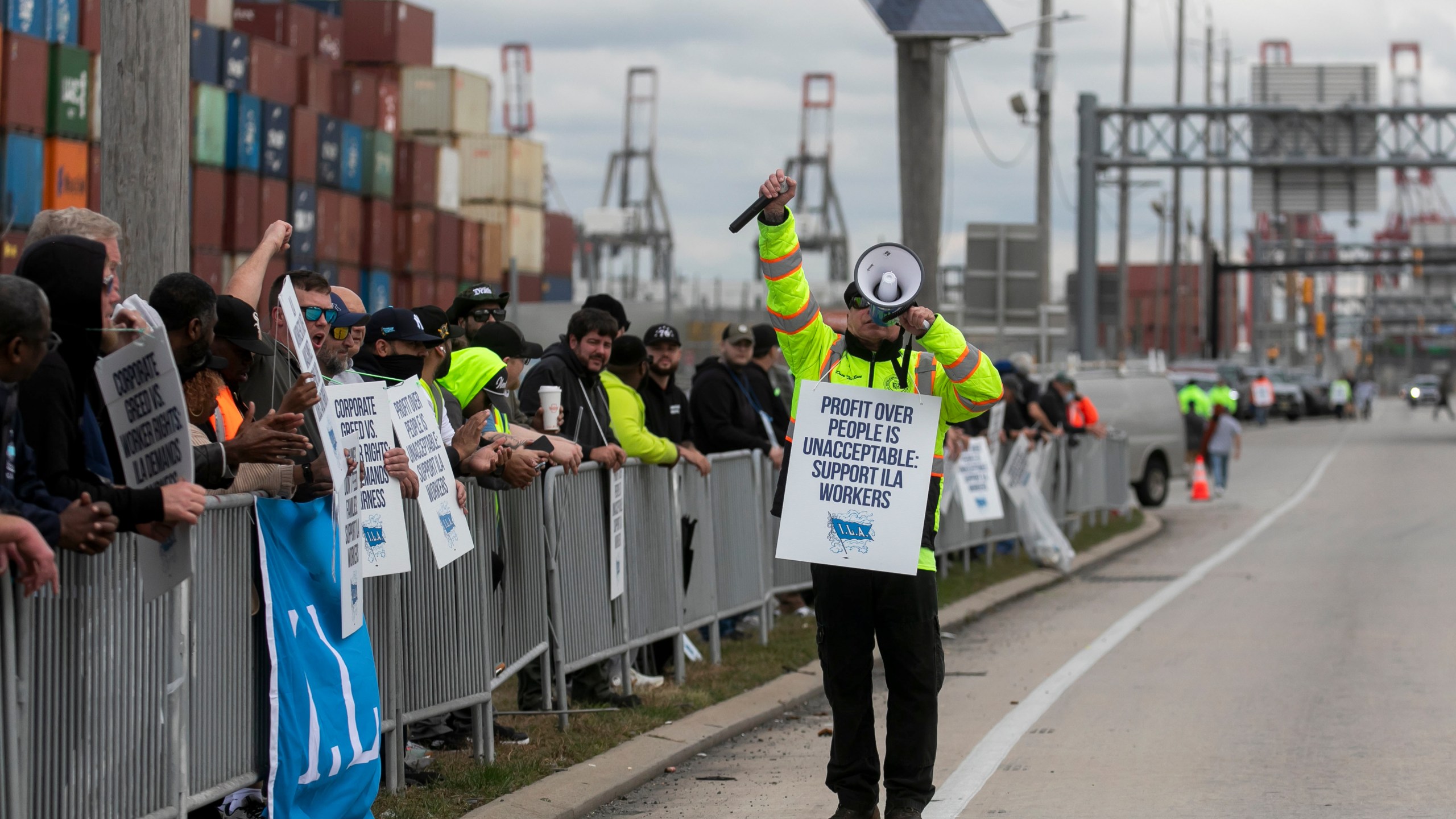 Workers picket outside of the APM container terminal at the Port of Newark in Newark, New Jersey, US, on Tuesday, Oct. 1, 2024.