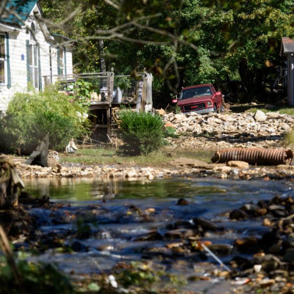 Jason Young clears debris and spreads loose dirt at his home off Flat Creek Road on October 2, 2024 in Black Mountain, North Carolina.