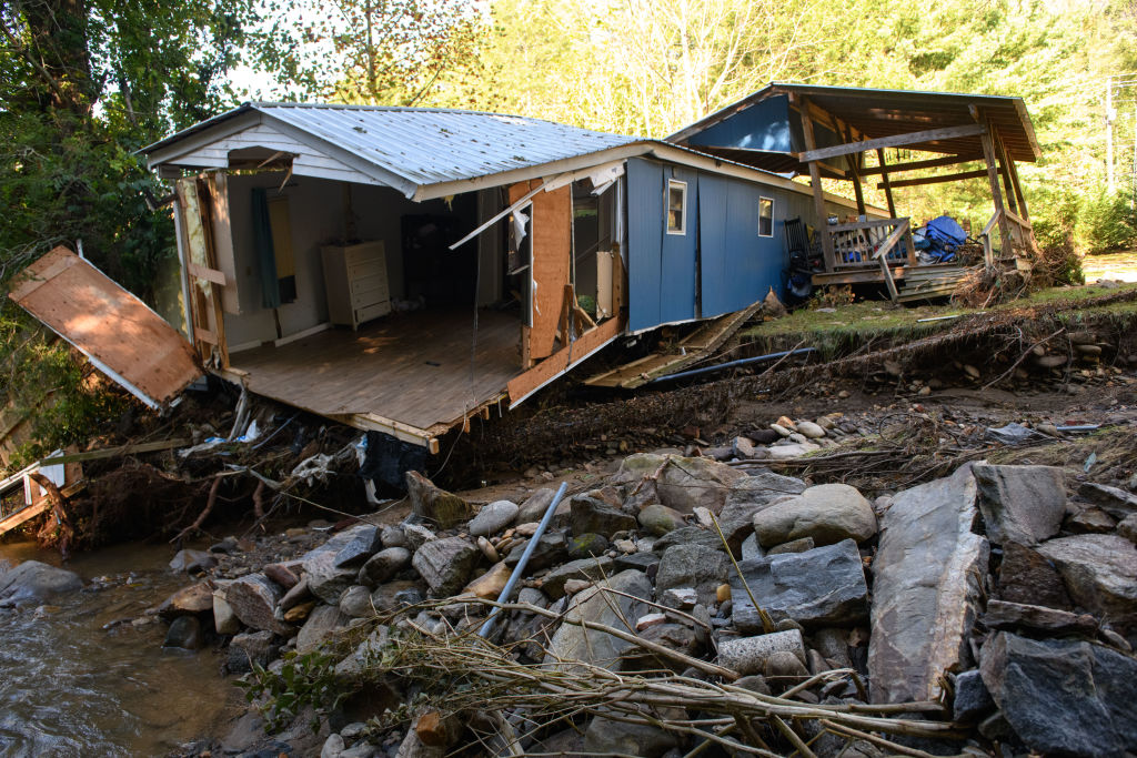 Damage to homes and vehicles along with evidence of re-routed streams can be seen on October 2, 2024 in Black Mountain, North Carolina.