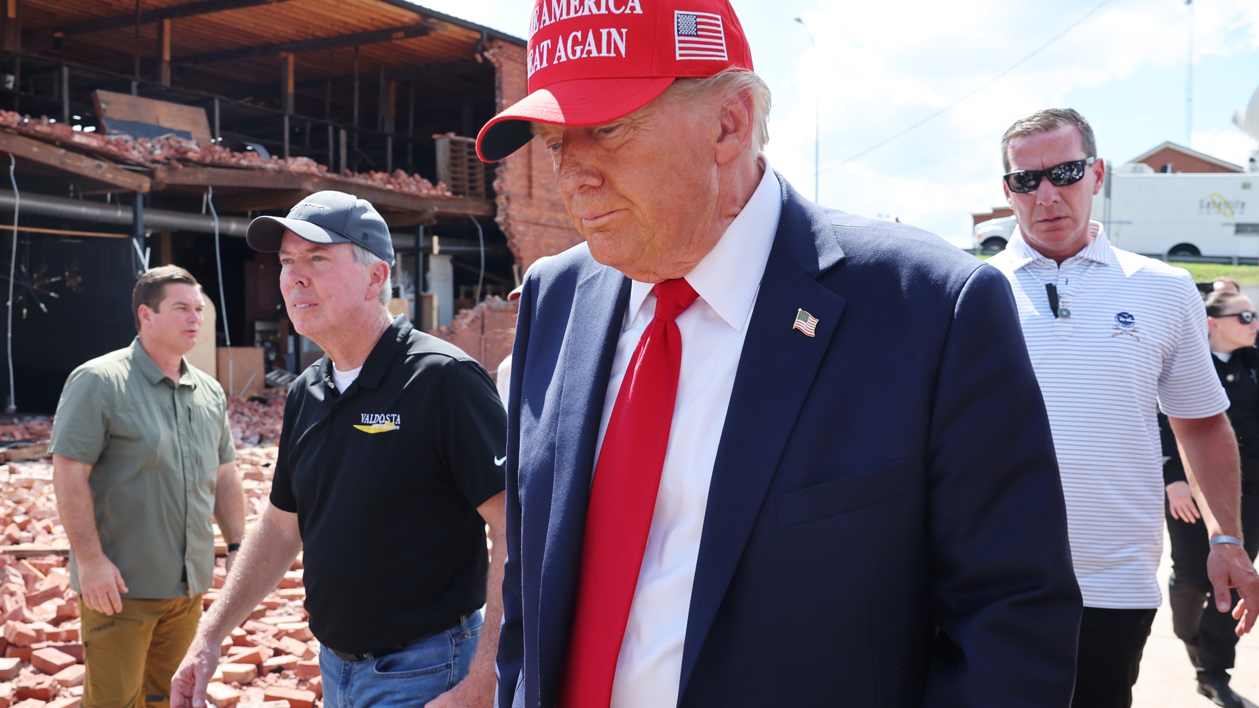 Former U.S. President Donald Trump prepares to leave after visiting Chez What Furniture store that was damaged during Hurricane Helene on September 30, 2024 in Valdosta, Georgia.