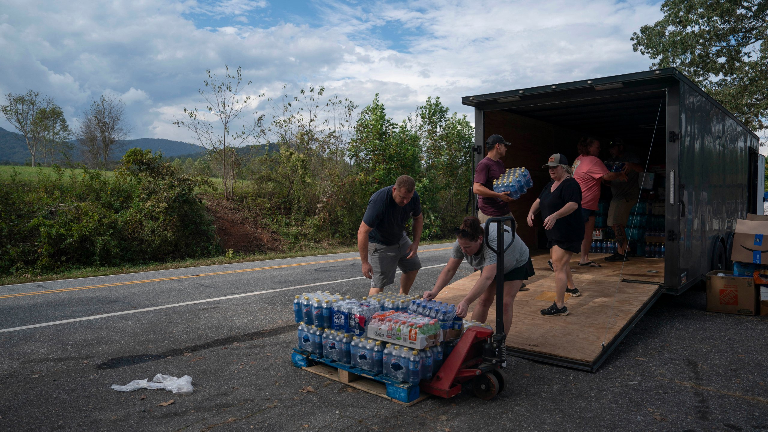 People load supplies for a search and relief mission in Bills Creek, North Carolina after the passage of Hurricane Helene.