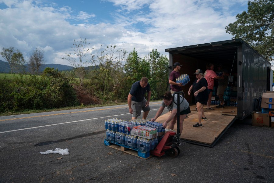 People load supplies for a search and relief mission in Bills Creek, North Carolina after the passage of Hurricane Helene.