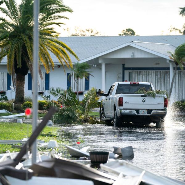 A motorist drives through a flooded street in the aftermath of Hurricane Milton on October 10, 2024 in Osprey, Florida.