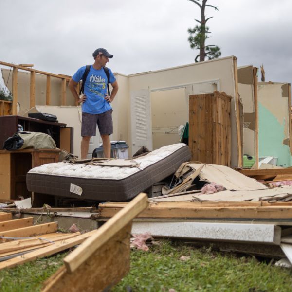 A Lakewood Park, Florida, resident stands among what's left of his home that was destroyed by a tornado spawned by Hurricane Milton.