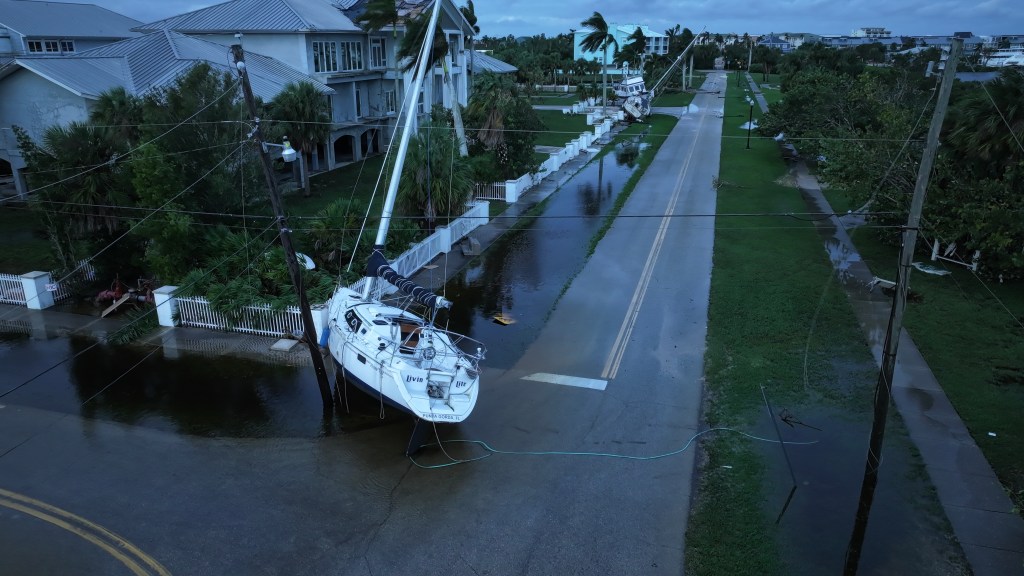 A boat rests in a street after it was washed ashore by Hurricane Milton.