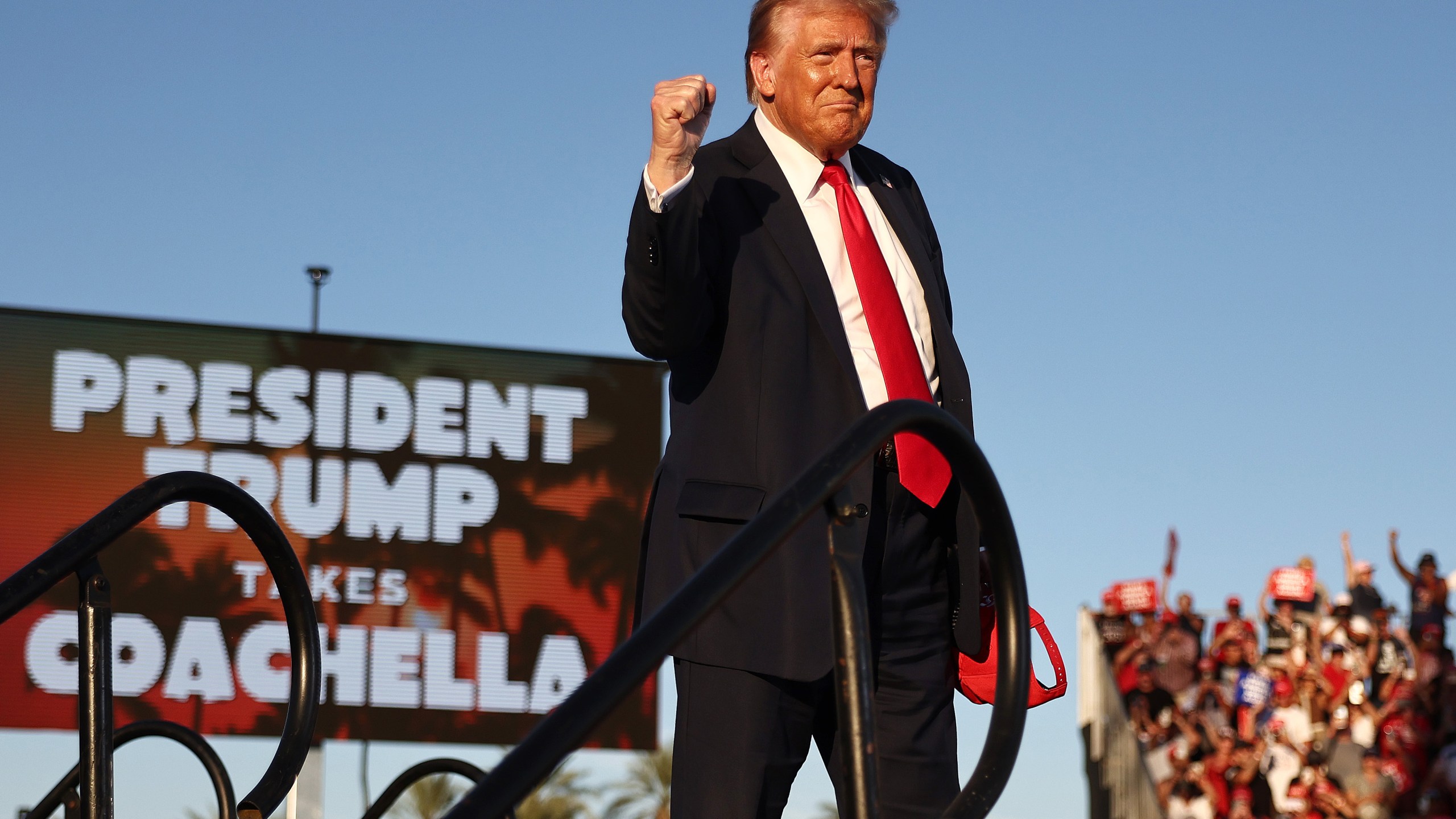 Republican presidential nominee, former U.S. President Donald Trump, gestures while walking onstage.