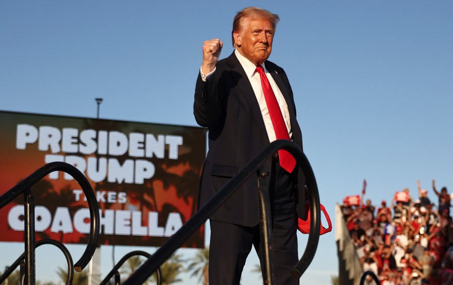 Republican presidential nominee, former U.S. President Donald Trump, gestures while walking onstage.