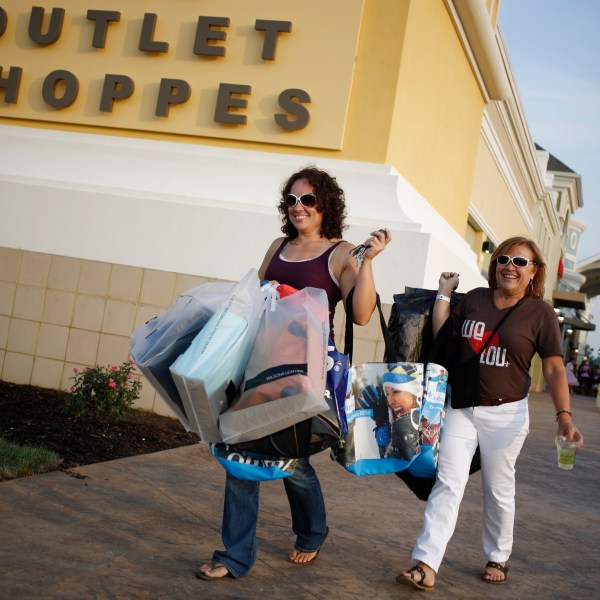 Shoppers walk to their cars at an outlet mall in Kentucky.