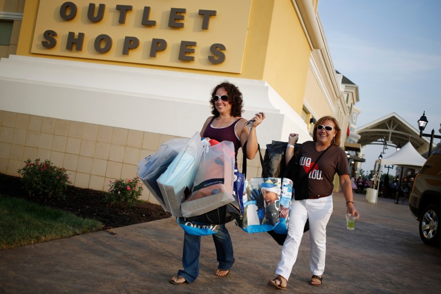 Shoppers walk to their cars at an outlet mall in Kentucky.