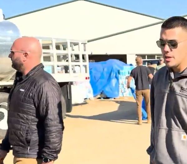 Two men outside a warehouse