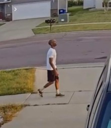 Surveillance footage of a black man walking.