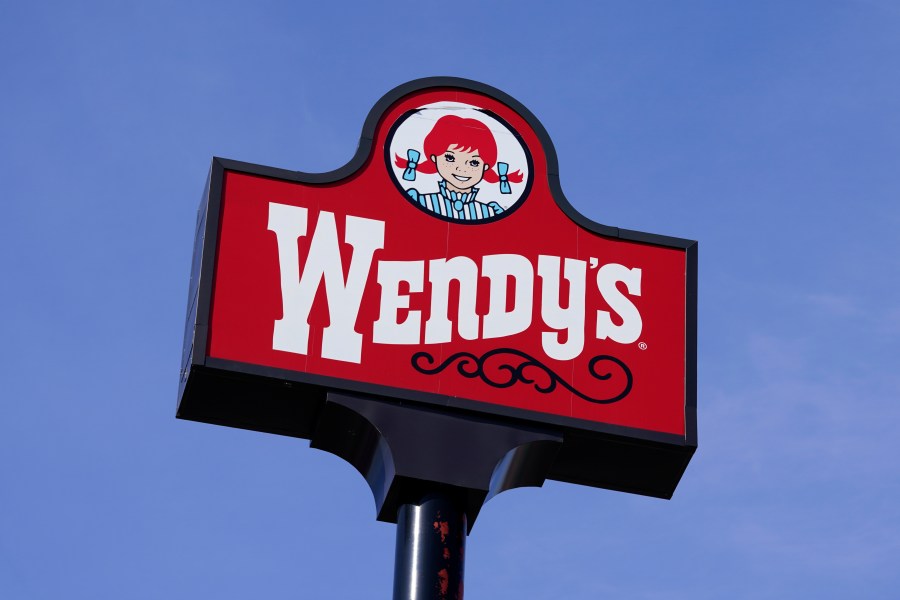 FILE - A sign for Wendy's restaurant stands over one of its locations, Feb. 25, 2021, in Des Moines, Iowa. (AP Photo/Charlie Neibergall, File)