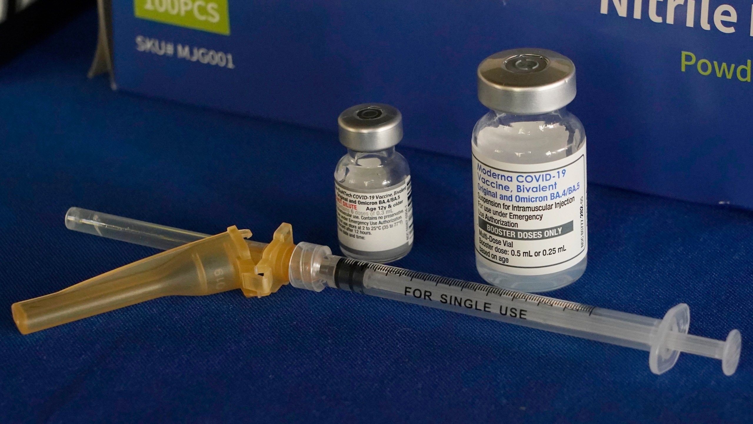 FILE - A syringe lies next to vials of COVID-19 booster vaccines at an inoculation station in Jackson, Miss., Friday, Nov. 18, 2022. (AP Photo/Rogelio V. Solis, File)