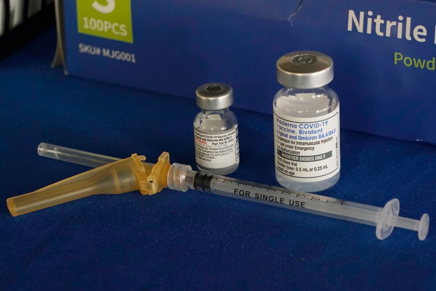 FILE - A syringe lies next to vials of COVID-19 booster vaccines at an inoculation station in Jackson, Miss., Friday, Nov. 18, 2022. (AP Photo/Rogelio V. Solis, File)