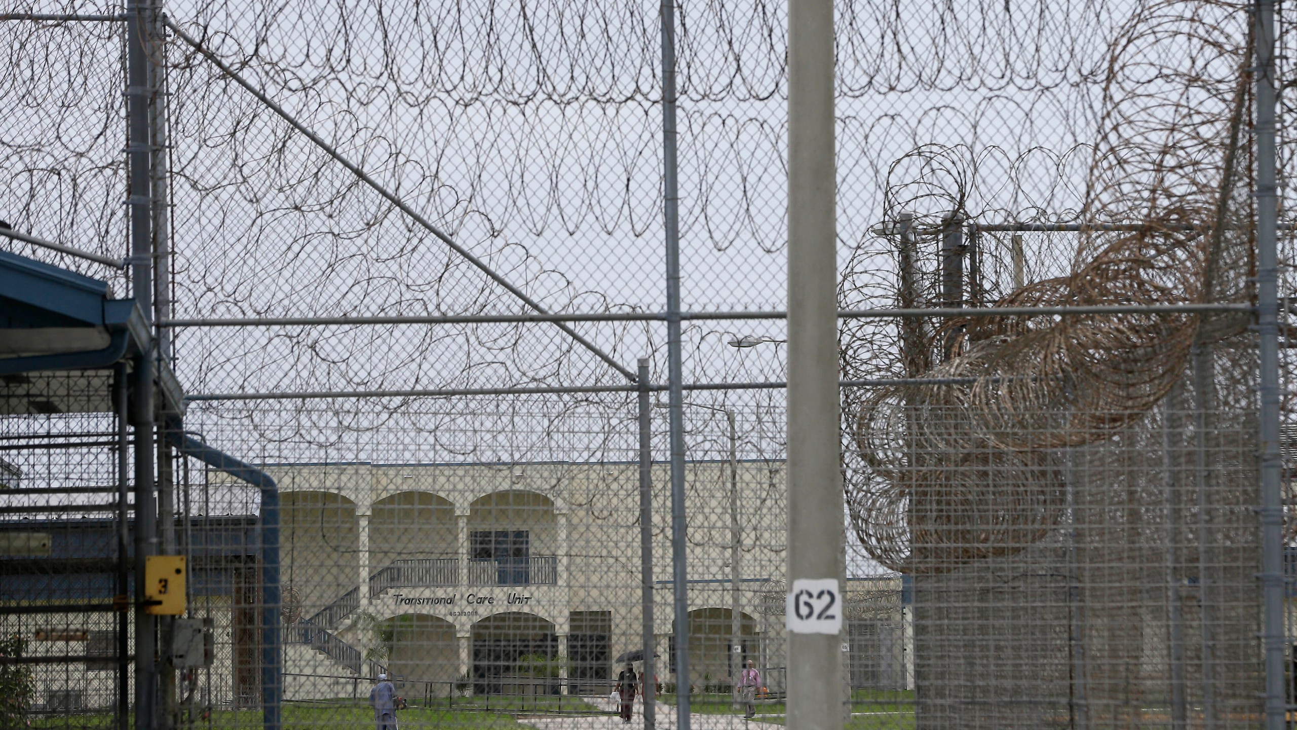 FILE - A prisoner works on the lawn at the Dade Correctional Institution, July 10, 2014, in Florida City, Fla. (AP Photo/Lynne Sladky, File)