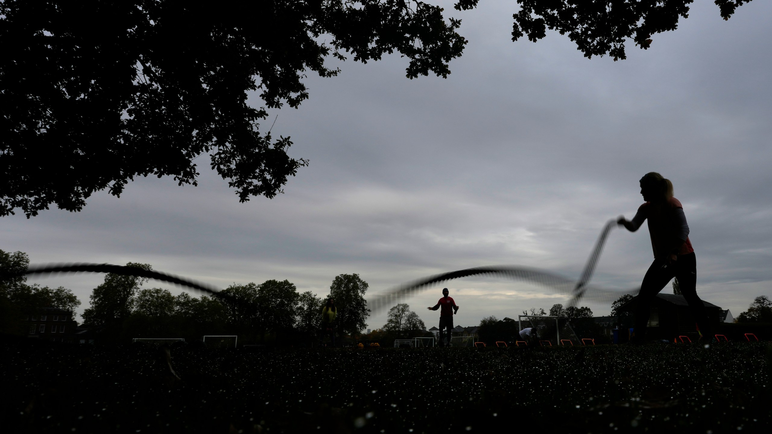 A participant takes part in an outdoor gym class led by personal fitness trainer Richard Lamb in London, Saturday, Oct. 26, 2024, Lamb works for Alan Ezen, and his company Zen Training. (AP Photo/Alastair Grant)