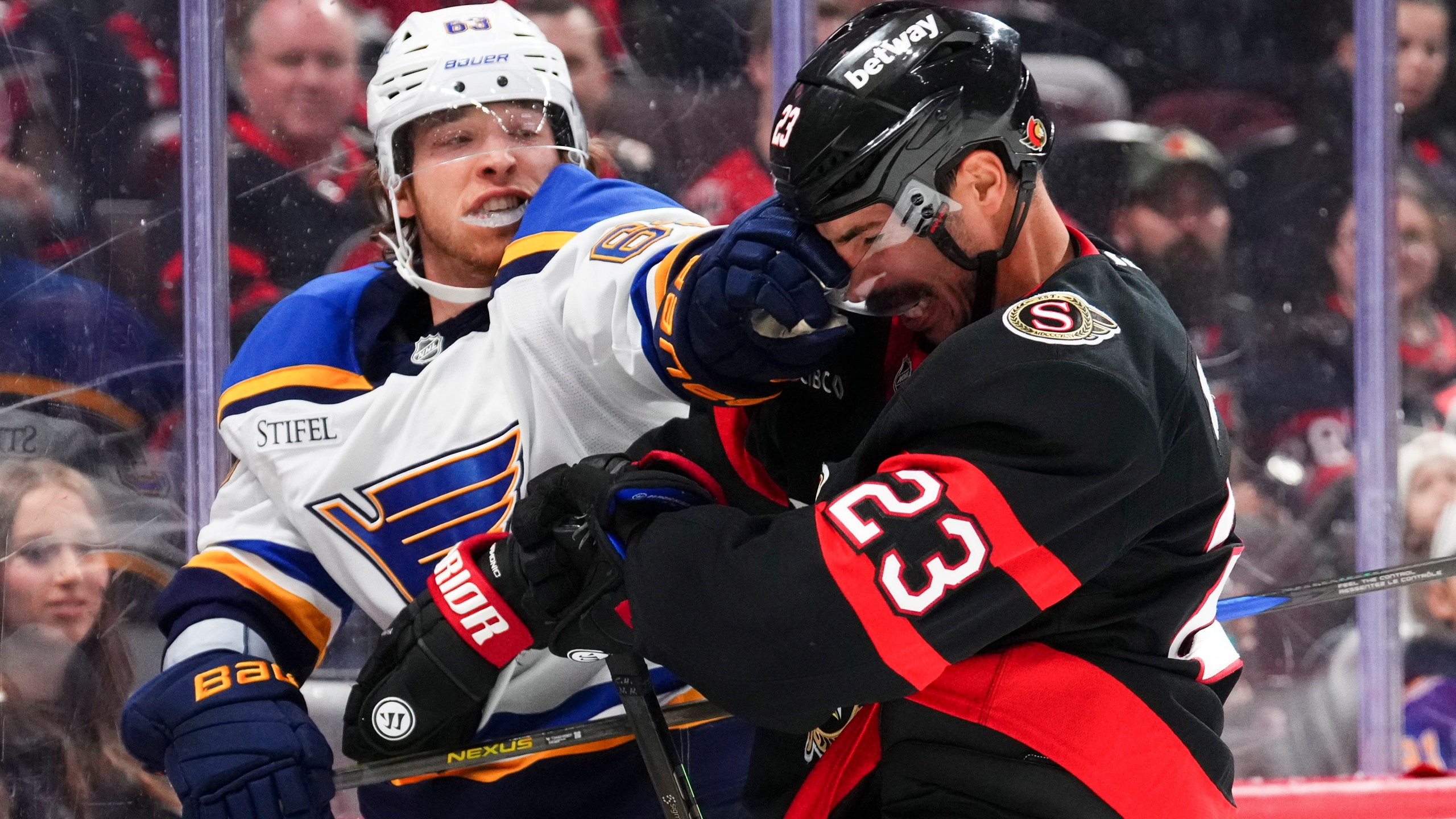 St. Louis Blues left wing Jake Neighbours hits Ottawa Senators defenseman Travis Hamonic (23) in the face as as tempers flair during first period of an NHL hockey game in Ottawa, Ontario, on Tuesday, Oct. 29, 2024. (Sean Kilpatrick/The Canadian Press via AP)