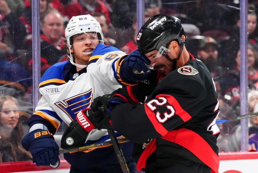 St. Louis Blues left wing Jake Neighbours hits Ottawa Senators defenseman Travis Hamonic (23) in the face as as tempers flair during first period of an NHL hockey game in Ottawa, Ontario, on Tuesday, Oct. 29, 2024. (Sean Kilpatrick/The Canadian Press via AP)