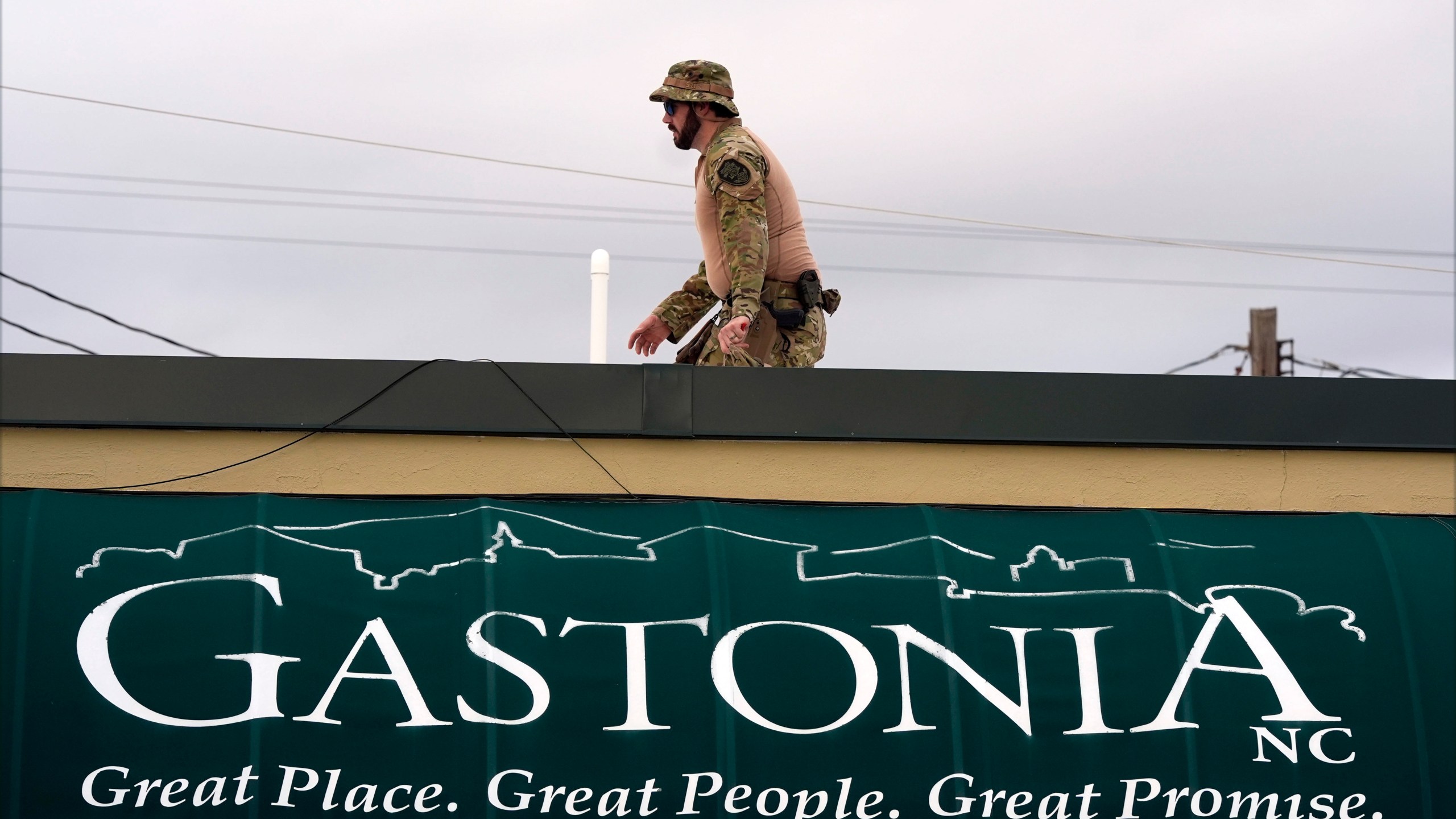 A member of law enforcement takes position before Republican presidential nominee former President Donald Trump speaks at a campaign rally in Gastonia, N.C., Saturday, Nov. 2, 2024. (AP Photo/Chris Carlson)