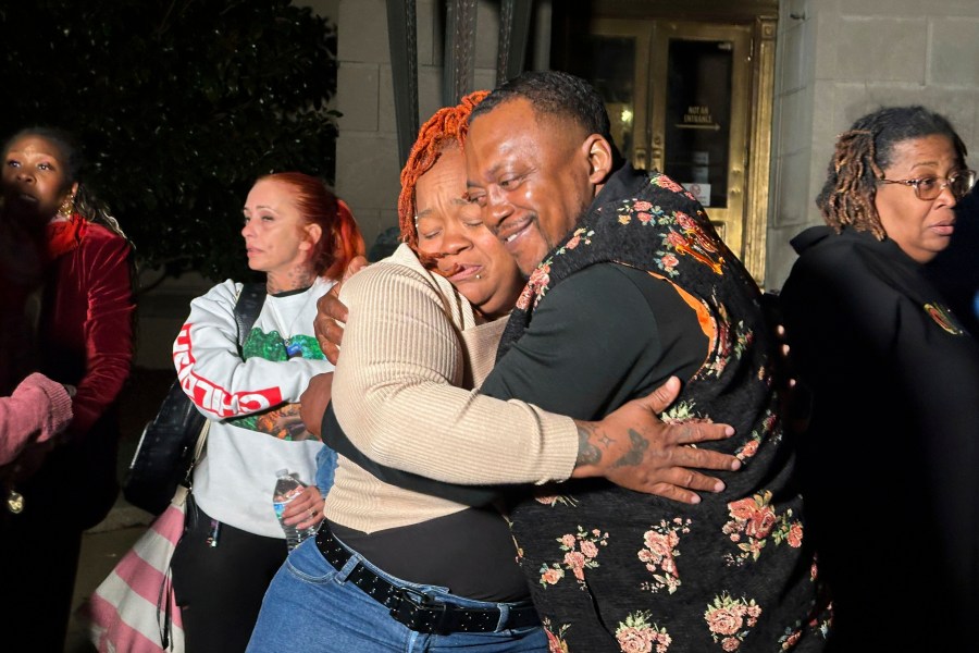 Breonna Taylor's mother, Tamika Palmer, center left, hugs a friend in Louisville, Ky., Friday, Nov. 1, 2024, after a former Kentucky police officer was convicted in federal court for using excessive force when he fired his gun during the deadly raid that left Taylor dead in 2020. (AP Photo/Dylan Lovan)