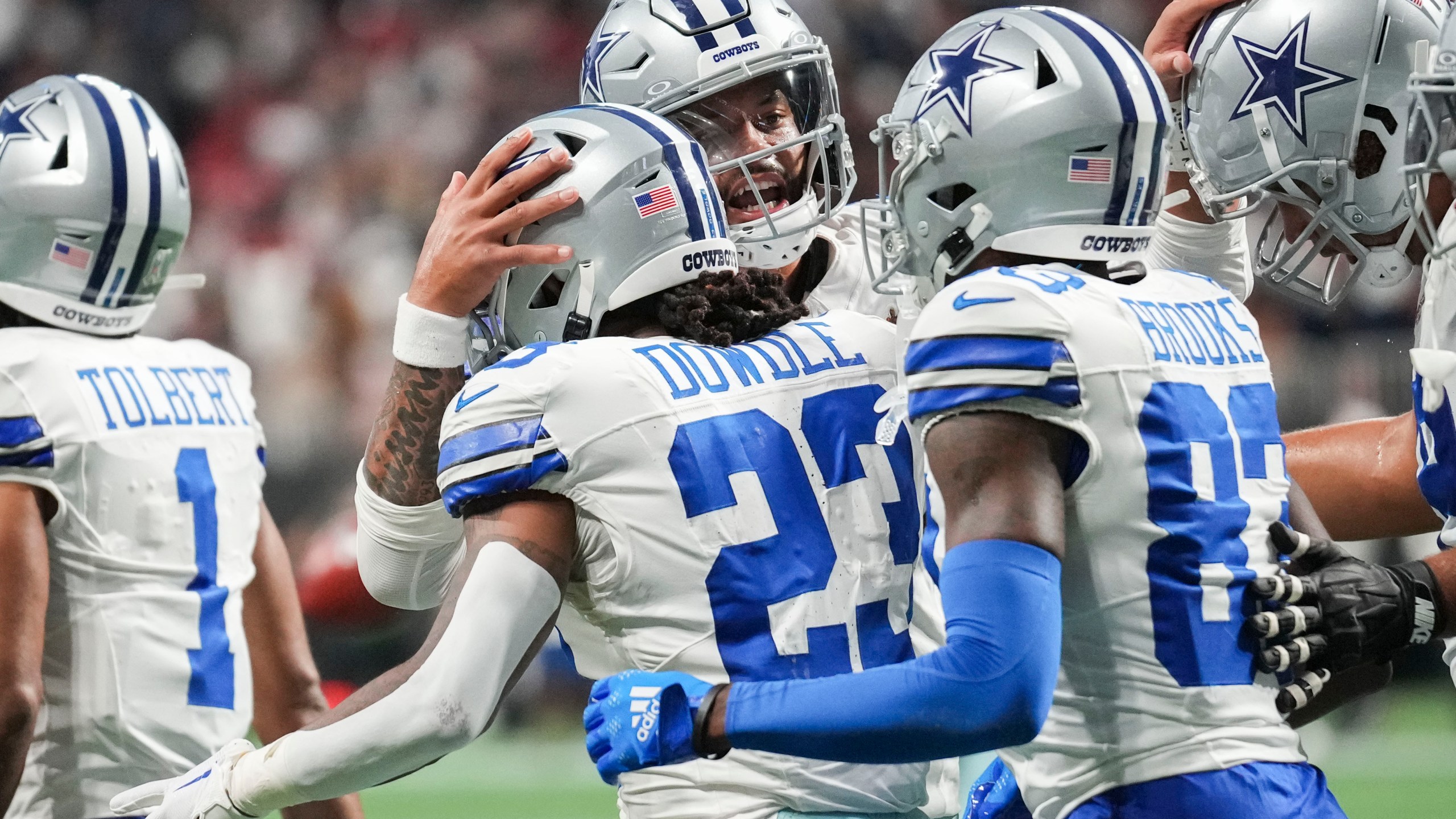 Dallas Cowboys running back Rico Dowdle (23) celebrates a touchdown reception with quarterback Dak Prescott and wide receiver Jalen Brooks during the first half of an NFL football game against Atlanta Falcons, Sunday, Nov. 3, 2024, in Atlanta. (AP Photo/ Brynn Anderson)